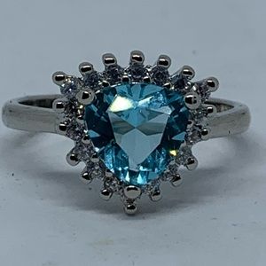 Blue topaz triangle surrounded by white topaz